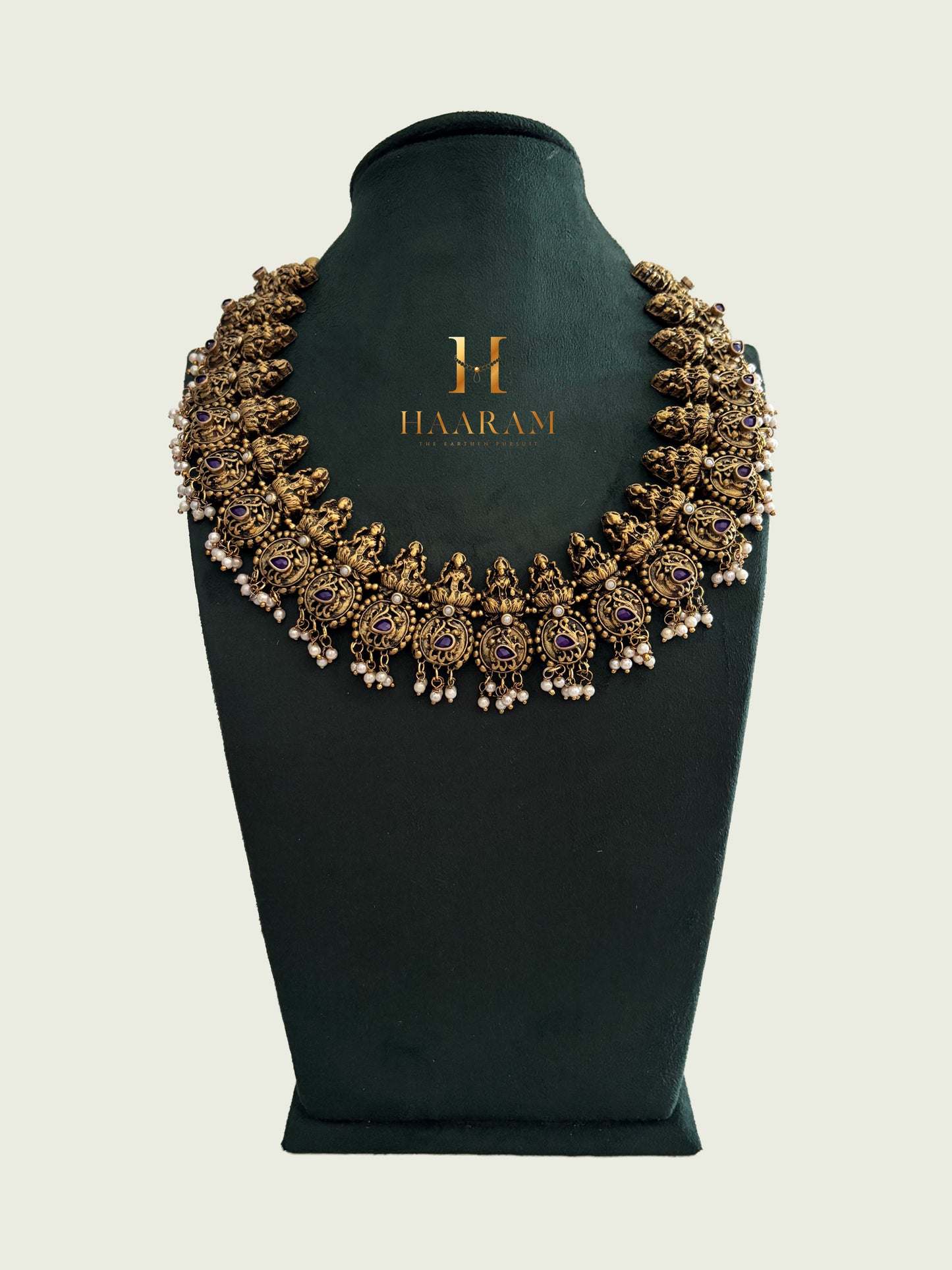 Intricately layered terracotta Lakshmi necklace with violet stones and pearl detailing from Haarambyyashh.