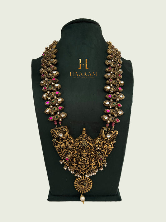 Statement terracotta necklace with deity carvings and traditional motif design in antique gold by Haarambyyashh.