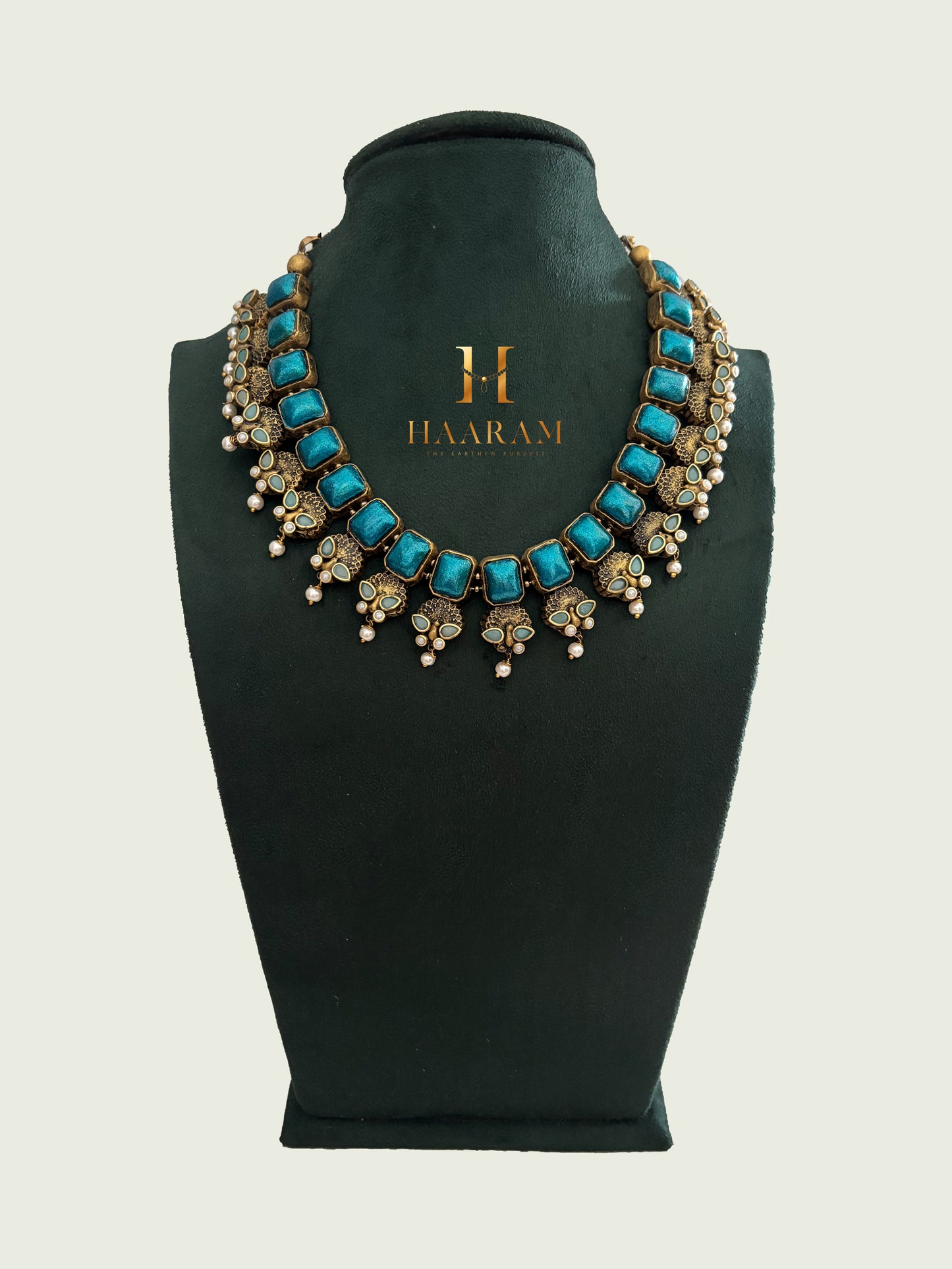 Blue terracotta necklace with pearl embellishments and antique gold finish by Haarambyyashh.