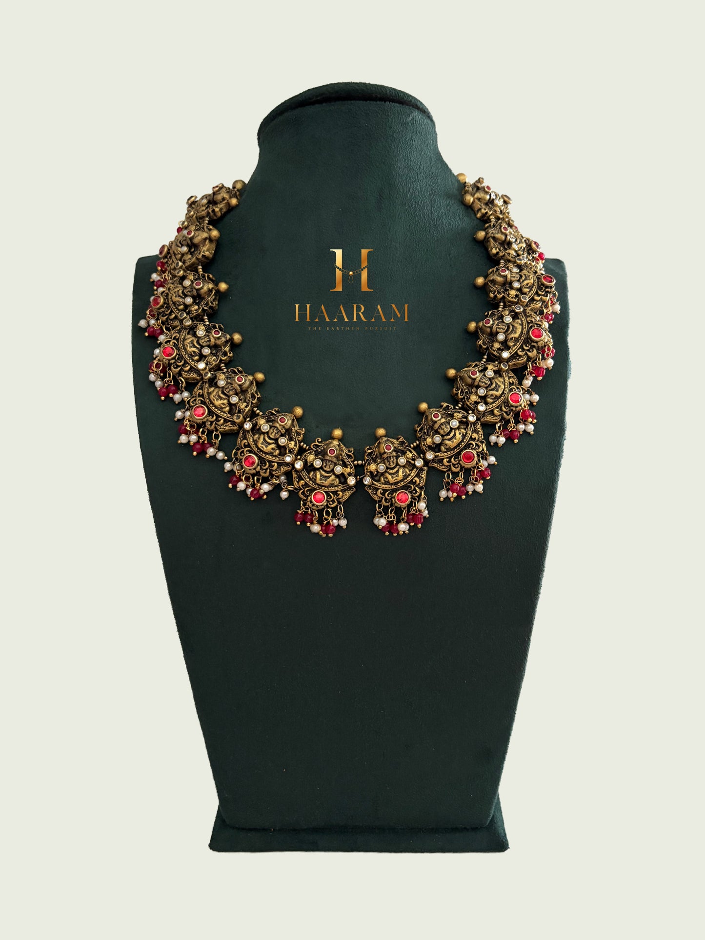 Sculpted terracotta choker necklace with red beads and antique finish by Haarambyyashh.