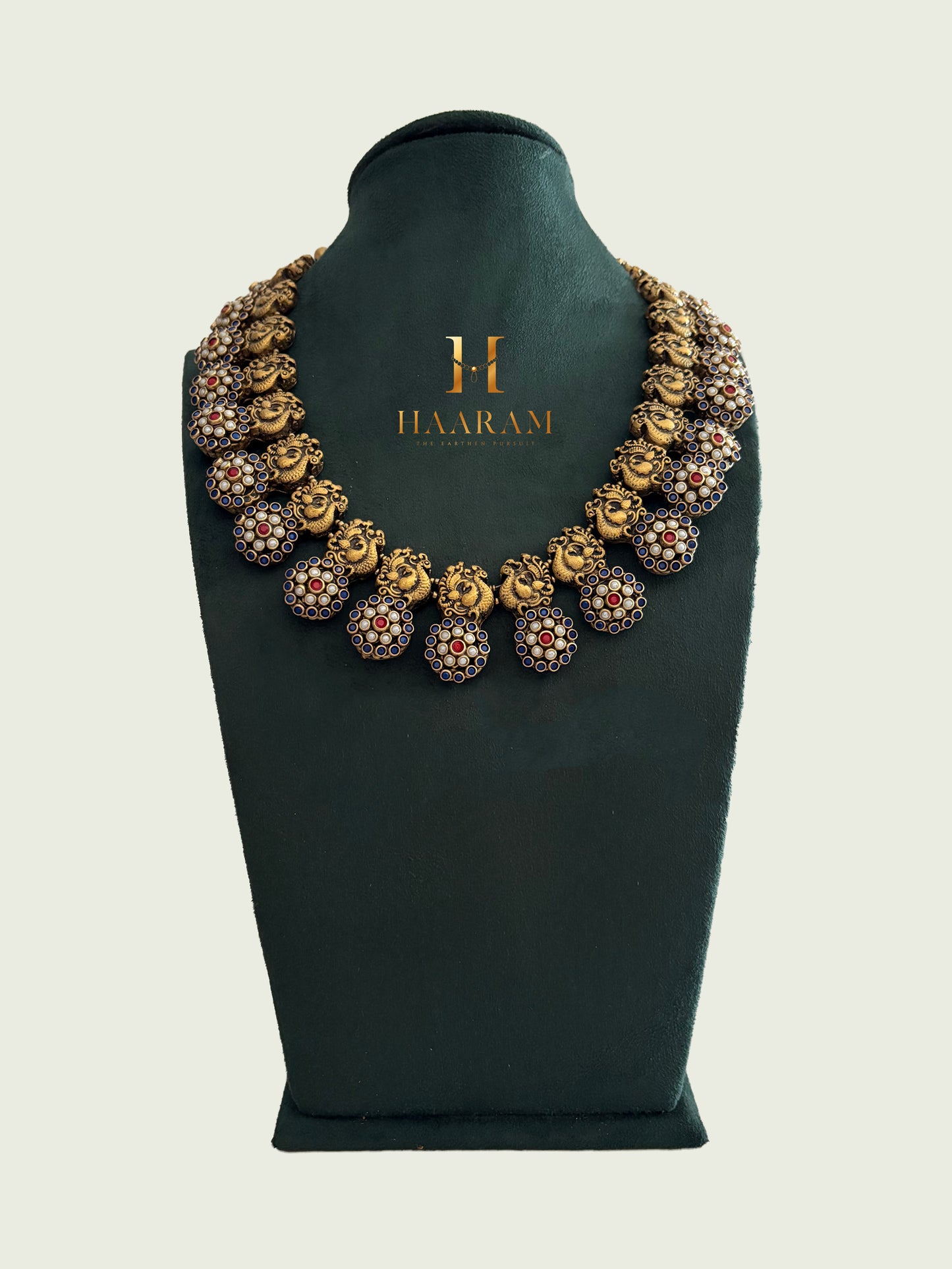 Terracotta necklace with round sculpted pendants and red-white stone inlays from Haarambyyashh.