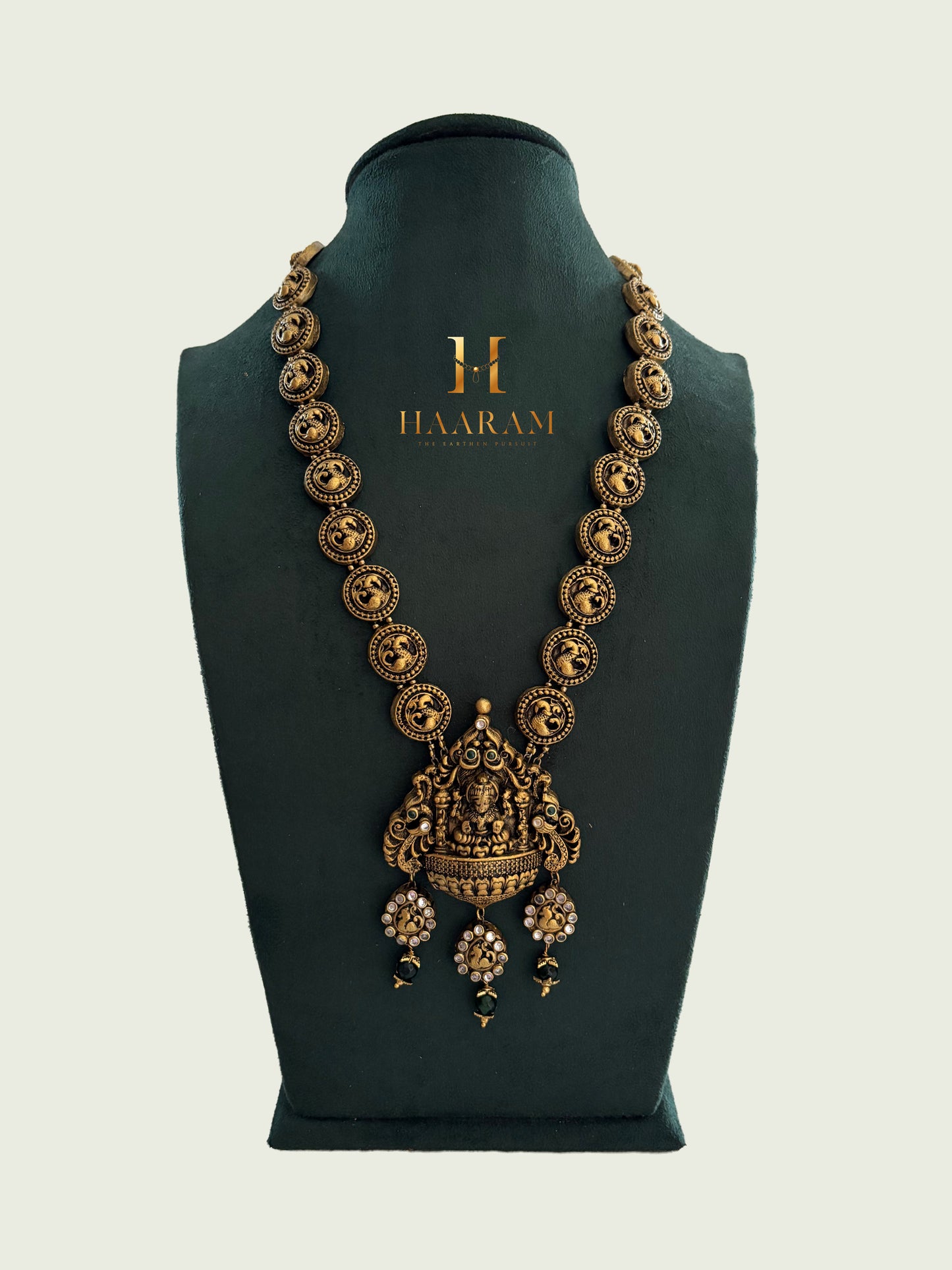 Terracotta coin necklace with Lakshmi Devi pendant and antique gold finish by Haarambyyashh.