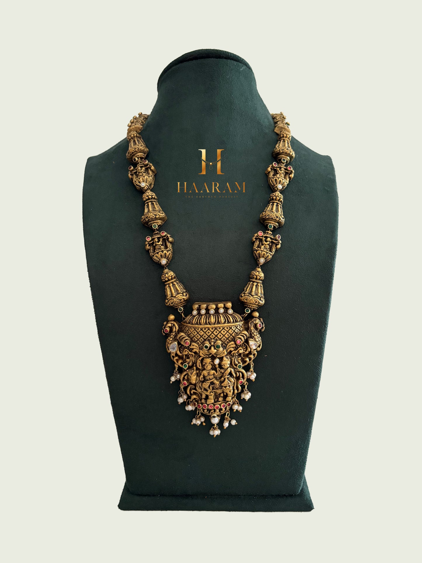 Handcrafted terracotta necklace with sculpted pendant and temple bell design by Haarambyyashh.