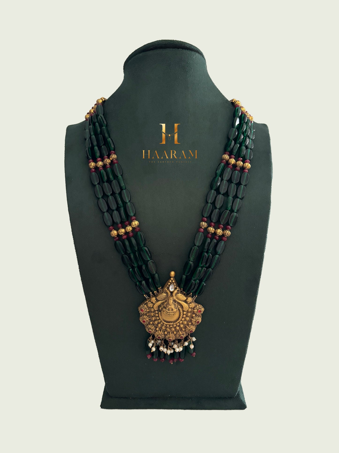 Green bead layered terracotta necklace with antique gold round pendant by HaarambyYashh.