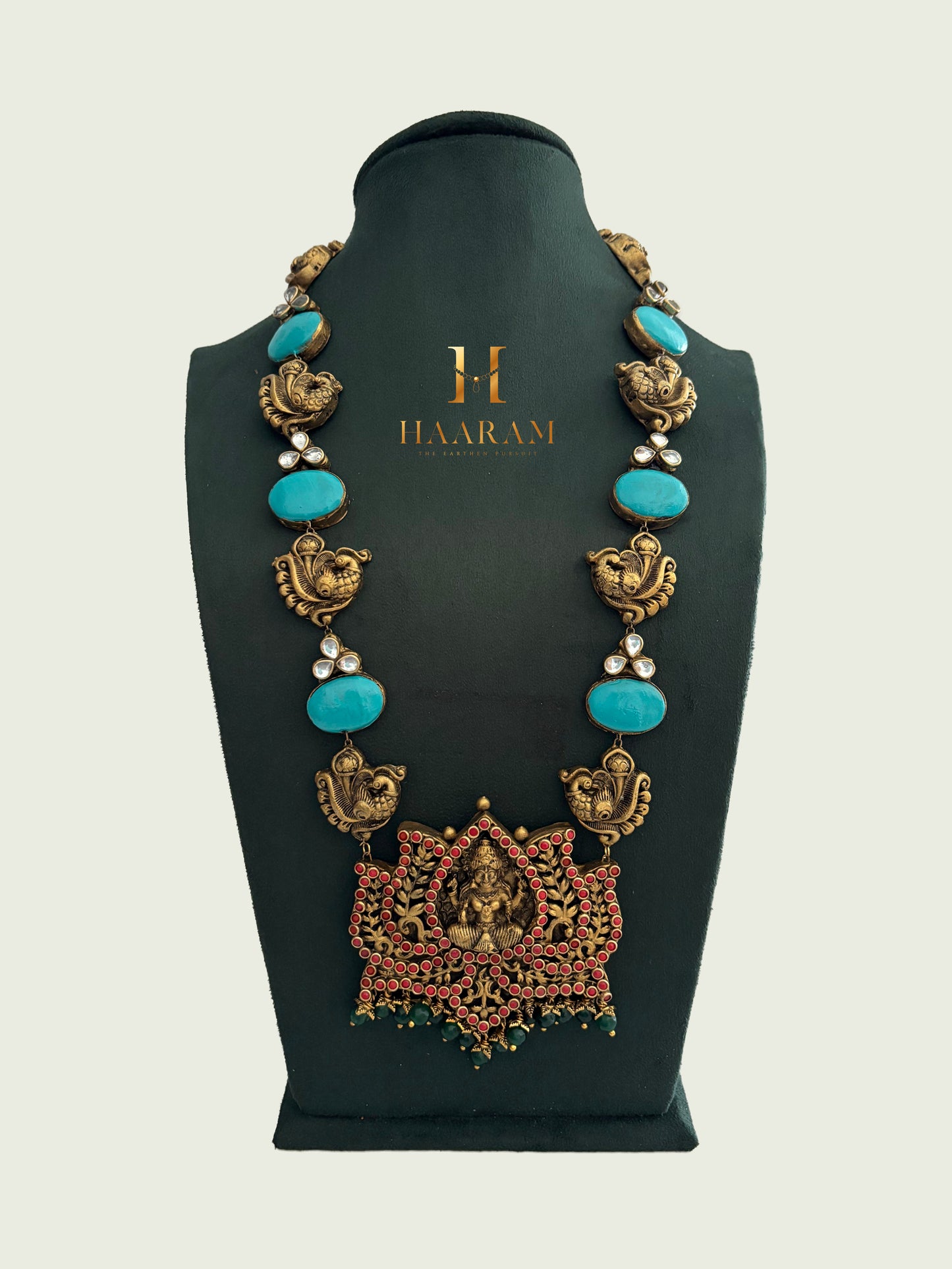 Handmade turquoise terracotta necklace with temple-style pendant in antique gold finish by HaarambyYashh.