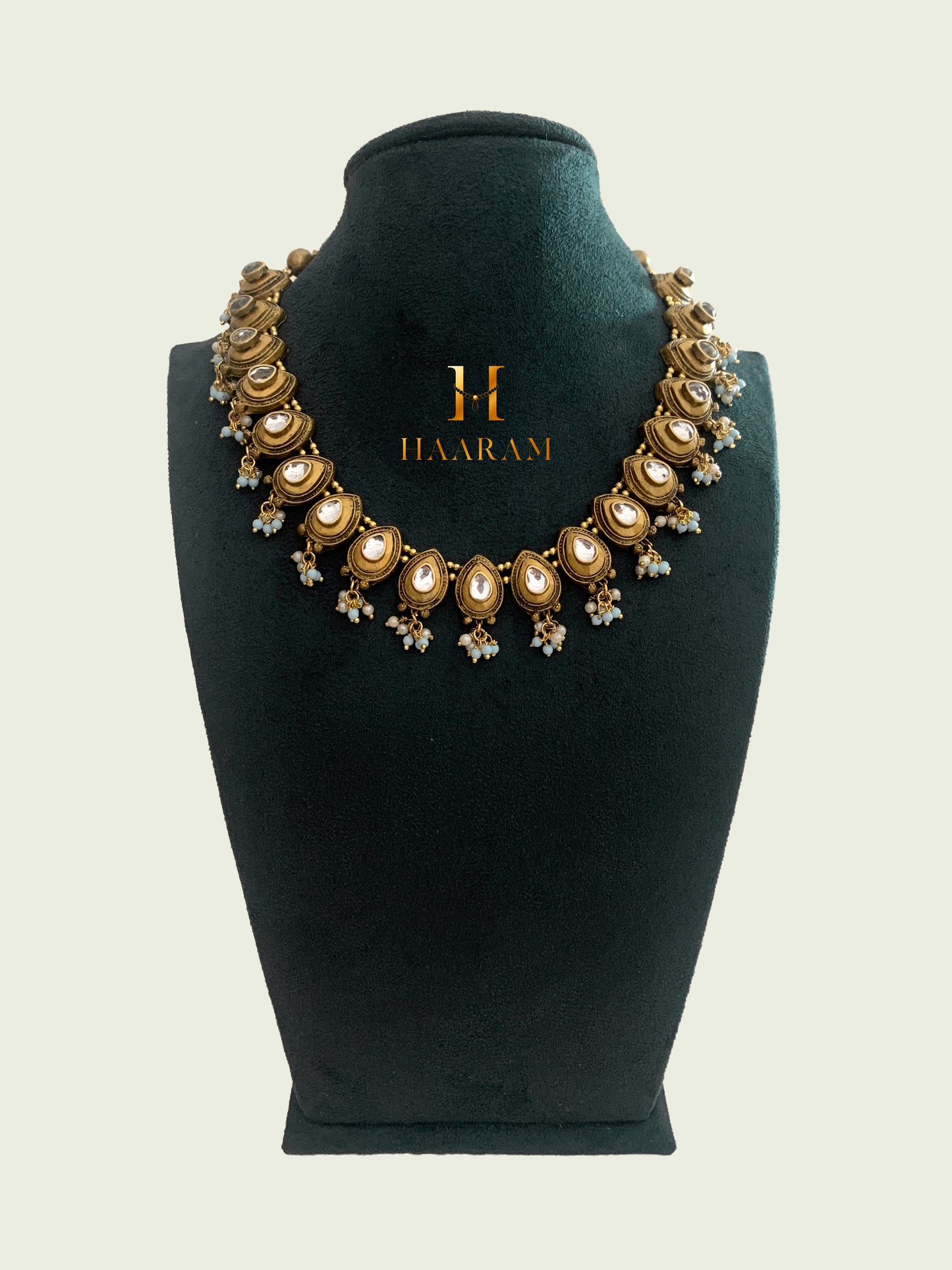 Elegant Terracotta necklace set with matching teardrop earrings from HaaramByYashh, featuring a series of pear-shaped white gemstones and delicate bead accents