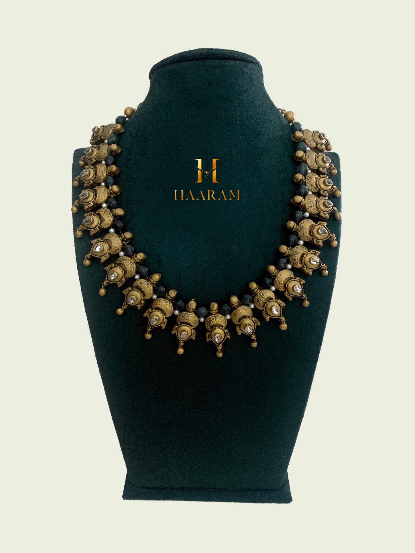 Traditional Terracotta necklace from Haarambyyashh. Features intricate peacock motifs and green bead accents, perfect for cultural and festive occasions. Elegant and detailed Indian jewelry design.