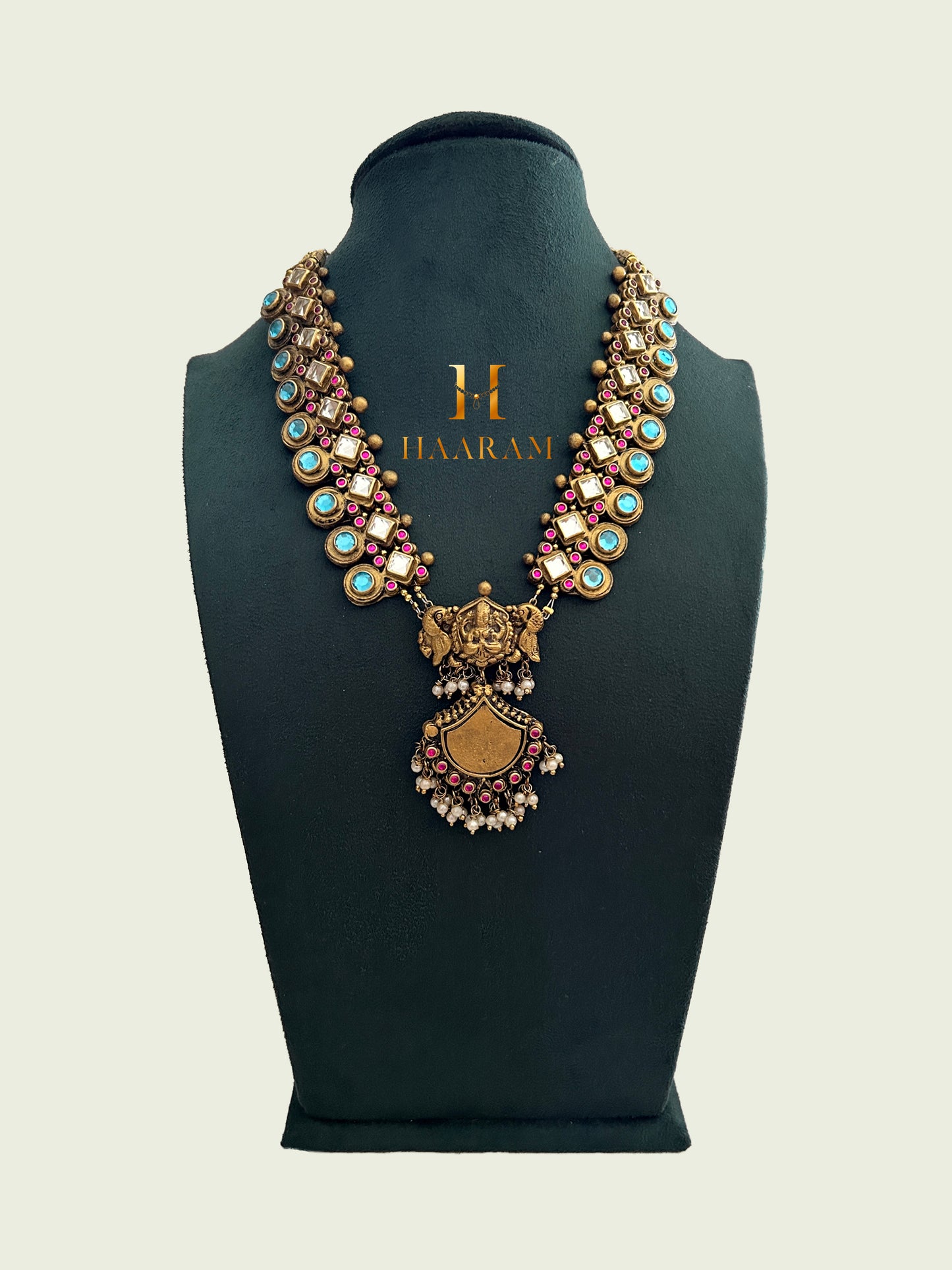 Antique Terracotta necklace with a dual-peacock motif and shield-shaped pendant, adorned with turquoise and ruby gemstones from Haarambyyashh