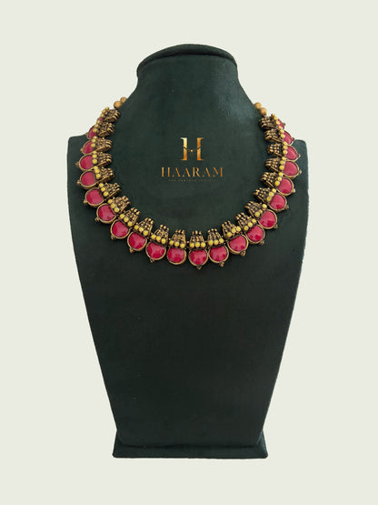 Ruby-red Kundan terracotta necklace with antique gold detailing by Haarambyyashh.