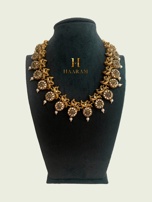 Traditional Terracotta necklace set from Haarambyyashh, featuring intricate floral and pearl motifs.  Elegant Indian jewelry design ideal for cultural and festive occasions.
