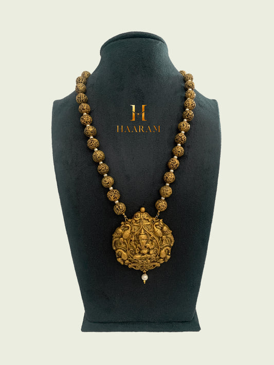 Traditional Antique Terracotta necklace from HaaramByYashh featuring a large, intricate pendant with deity motifs and detailed beadwork.  Elegant Indian jewelry design ideal for cultural and festive occasions.