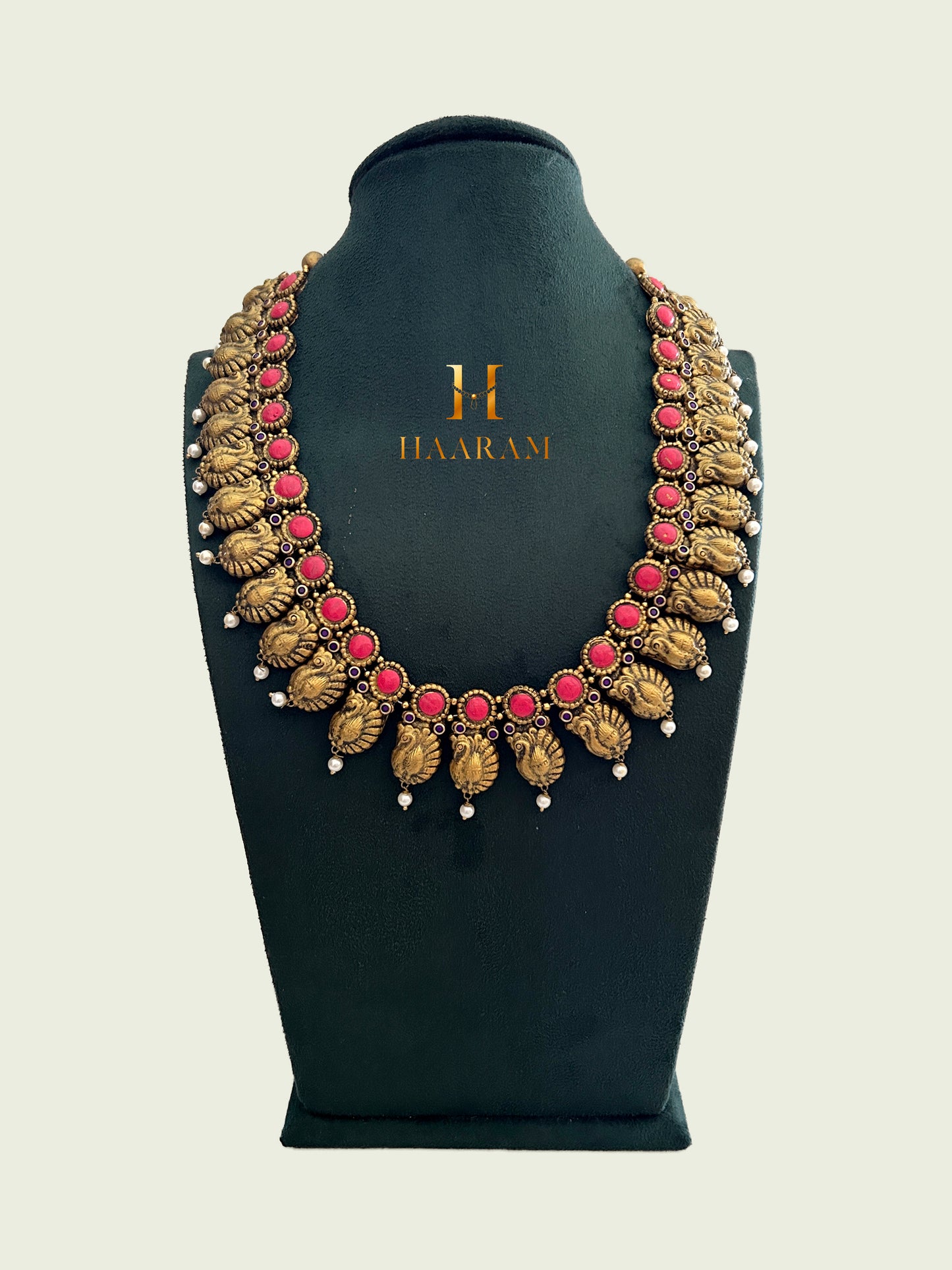 Antique Terracotta necklace with conch shell motifs and red gemstones, adorned with pearl accents from Haarambyashh