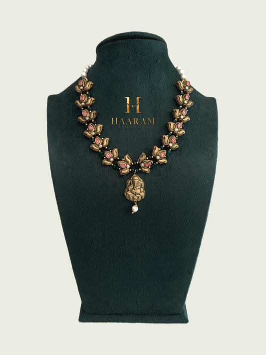 Terracotta necklace with lotus motifs and a Ganesha pendant, designed by Haarambyyashh.