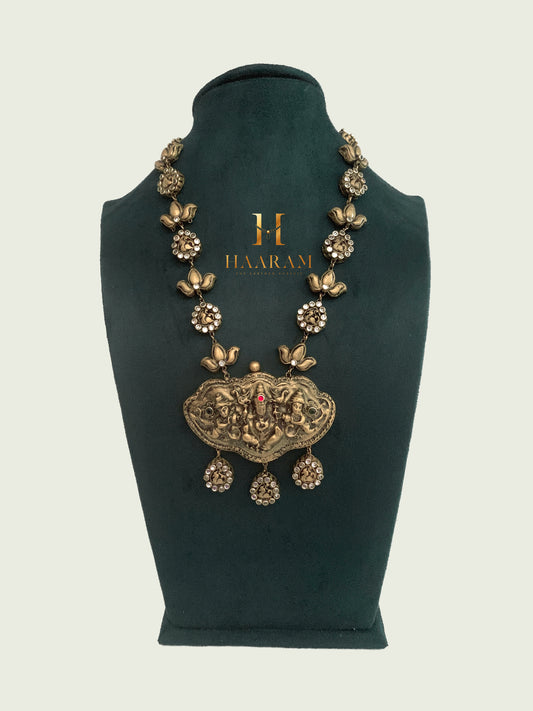 Floral pendant necklace with antique gold-tone pendant and floral motifs. Exquisite terracotta jewelry by Haaram by Yashh.