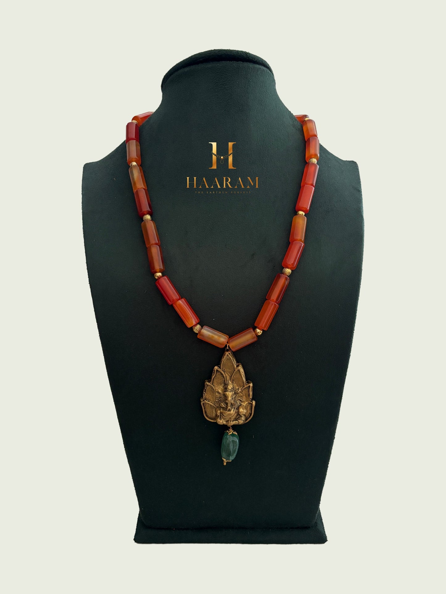 Necklace with orange beads and a leaf terracotta pendant by haarambyyashh