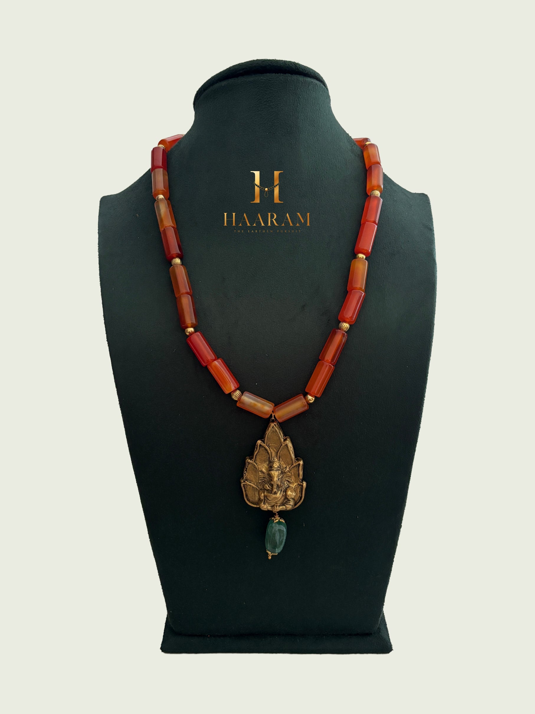 Necklace with orange beads and a leaf terracotta pendant by haarambyyashh