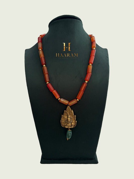 Necklace with orange beads and a leaf terracotta pendant by haarambyyashh