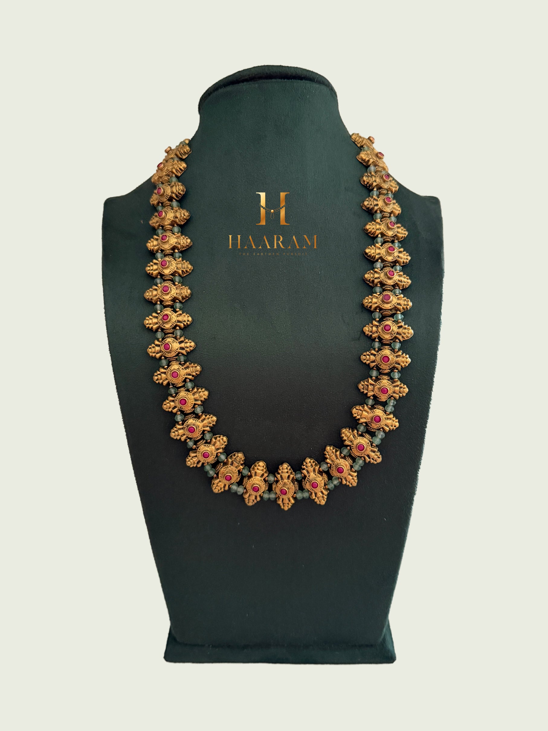 Statement terracotta necklace with handcrafted floral motifs, ruby stone accents and antique gold finish