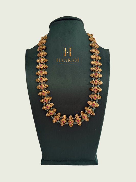 Statement terracotta necklace with handcrafted floral motifs, ruby stone accents and antique gold finish